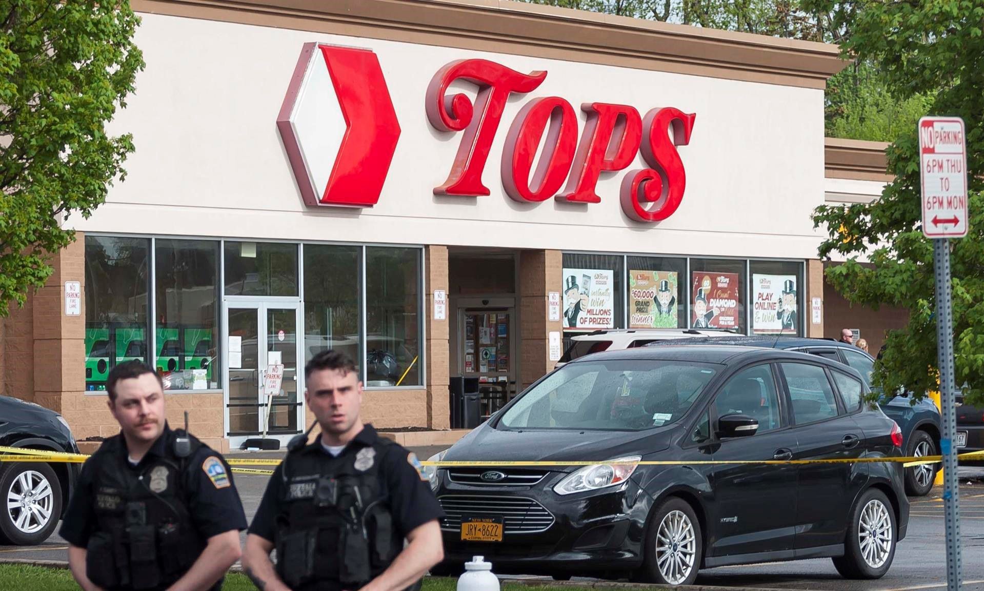 Police officers at the scene of a mass shooting at the Tops Friendly Market grocery store in Buffalo, New York, USA.  (EFE/EPA/BRANDON WATSON).