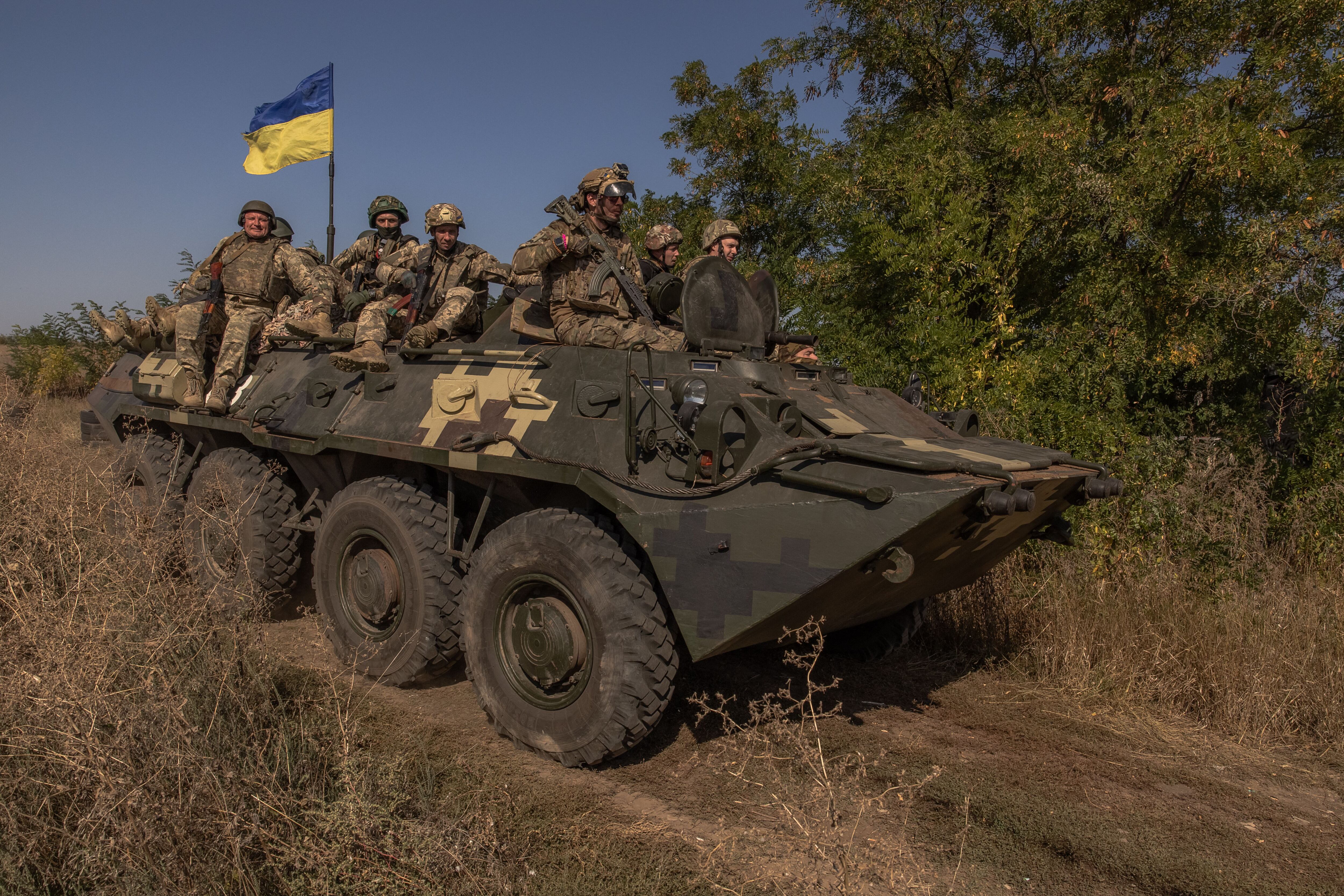 Ukrainian members of the OPFOR battalion ride atop an armored vehicle while participating in military training in the Donetsk region on September 26, 2023, amid Russia's invasion of Ukraine.  (Photo by Román PILIPEY/AFP).