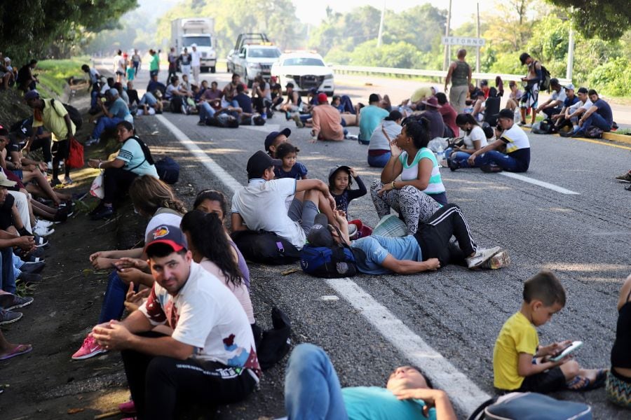Migrants rest as they are part of a caravan heading to the United States, in Huixtla, Mexico, April 30, 2022.