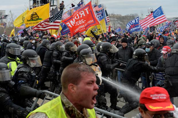 In this file photo taken on January 6, 2021, supporters of Donald Trump clash with police and security forces as they attempt to storm the US Capitol.