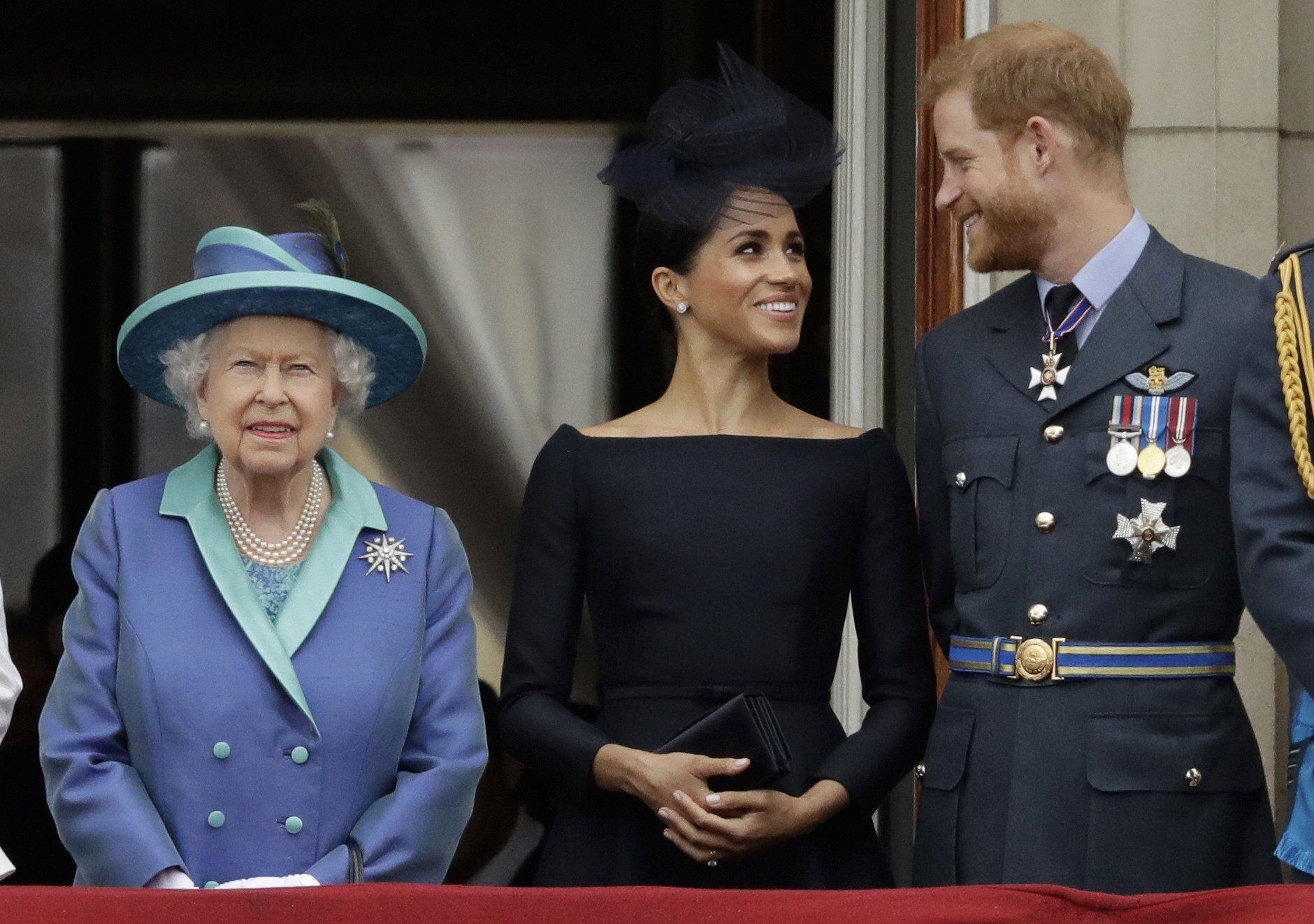 Queen Elizabeth II with the former Dukes of Sussex, Meghan and Harry.  AP