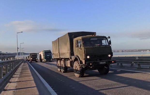 Russian military trucks cross a bridge linking the Russian-controlled Crimean peninsula to the mainland.  (AFP).