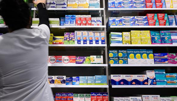 Un asistente farmacéutico sostiene una caja de medicamentos en una farmacia en Riedisheim, este de Francia, el 23 de octubre de 2023. (Foto de SEBASTIEN BOZON / AFP)