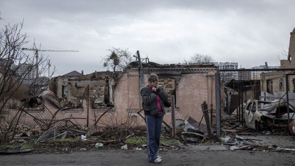 A woman amidst the devastation in Bucha, Ukraine.