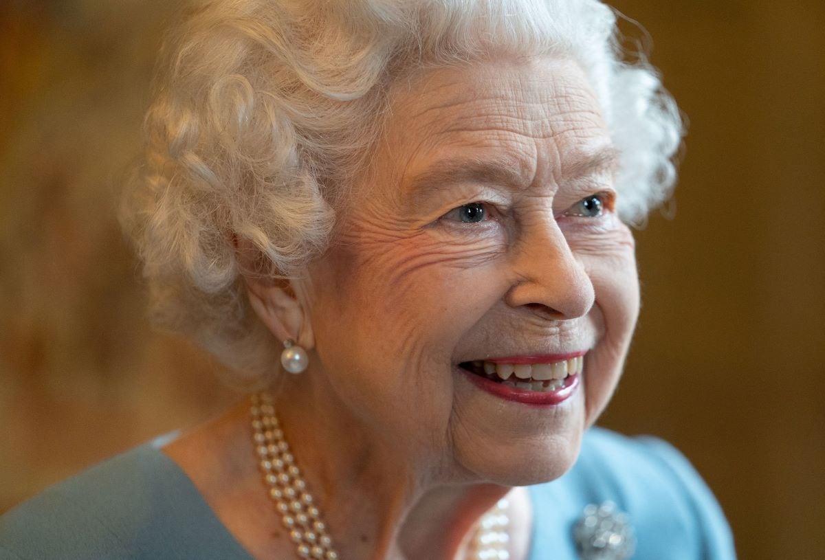 Britain's Queen Elizabeth II smiles during a reception in the ballroom of Sandringham House, the Queen's residence in Norfolk, on February 5, 2022. (Joe Giddens / AFP)