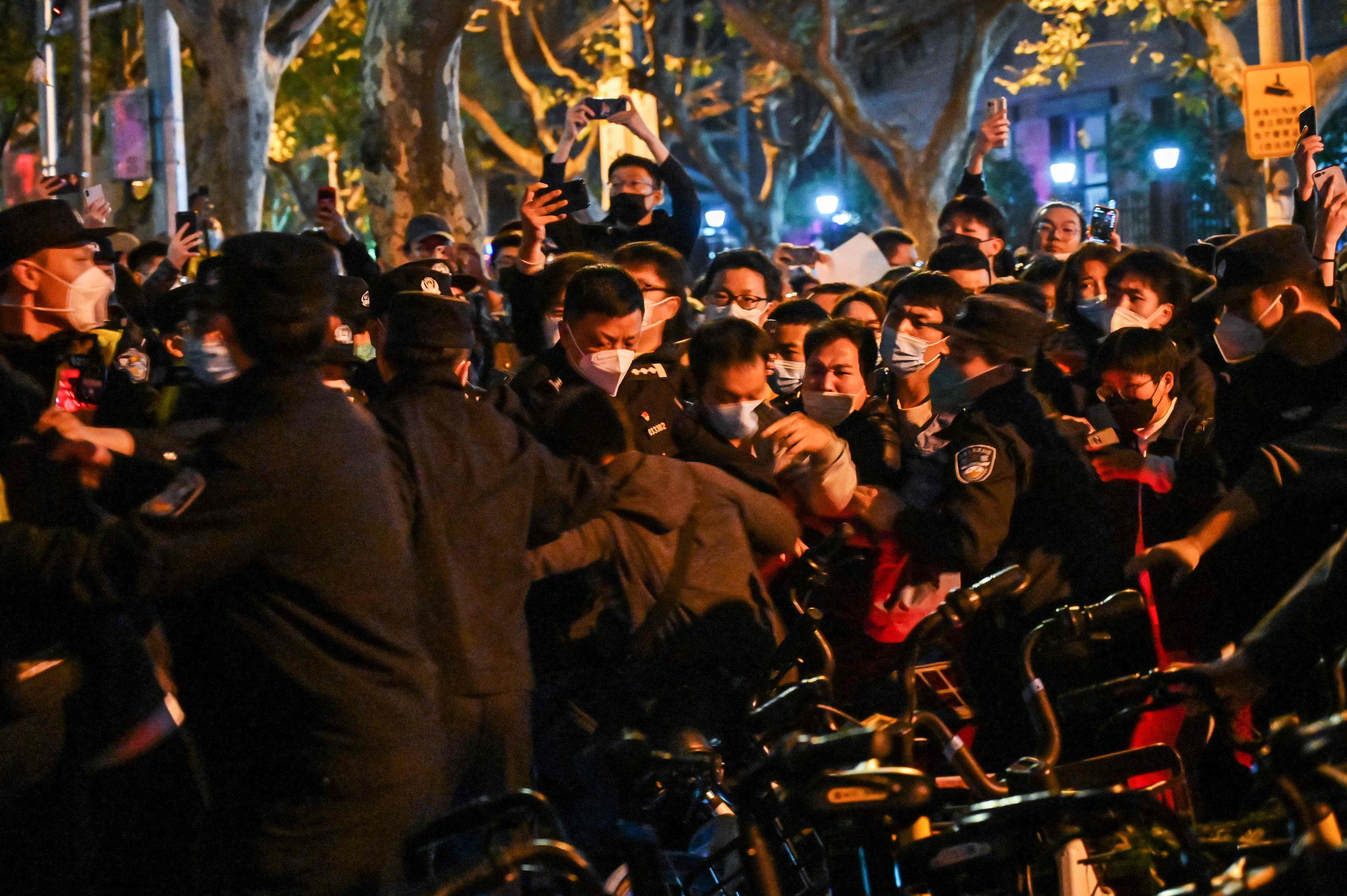 Police and people are pictured during some clashes in Shanghai.