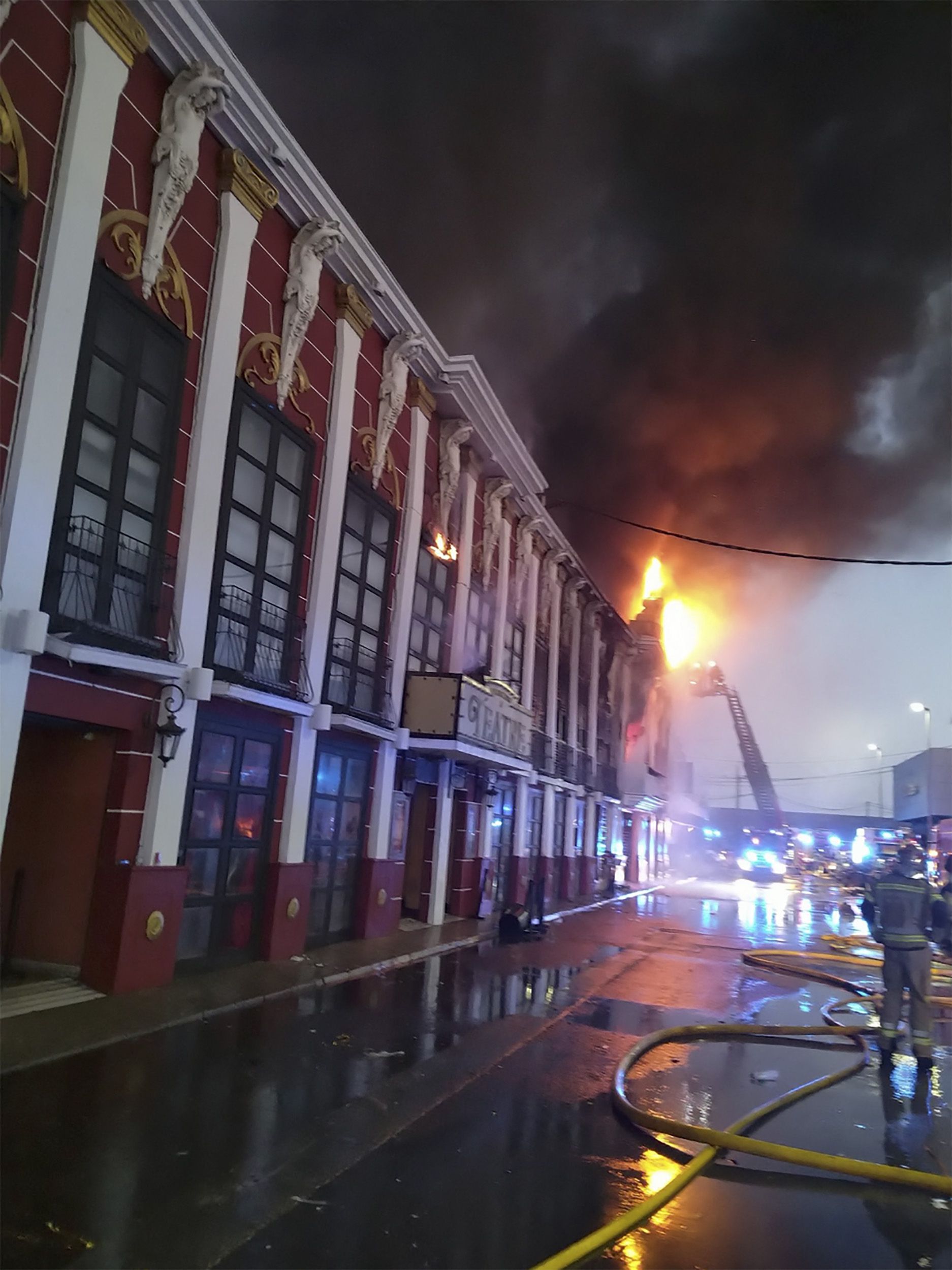 In this photograph provided by the Murcia Fire Department on October 1, 2023, an attempt is made to extinguish a fire in a nightclub area.  (AFP).