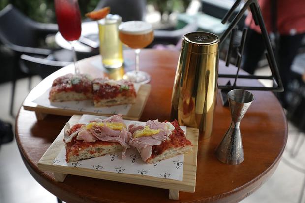 The taglios, pizza slices of focaccia bread, feed visitors to Hidden Bar with options of pepperoni, mushrooms, pineapple carpaccio, and flavors that vary each week.  (Photos: Britanie Arroyo)