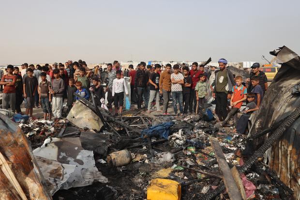 Palestinians gather at the site of an Israeli attack on a camp for internally displaced people in Rafah on May 27, 2024.