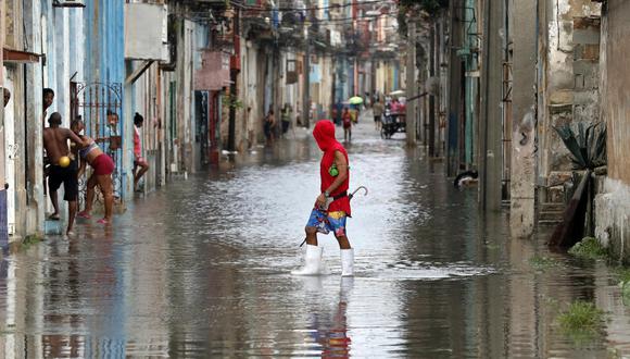 Un hombre cruza hoy una calle inundada, en La Habana (Cuba). (Foto: EFE/Ernesto Mastrascusa)