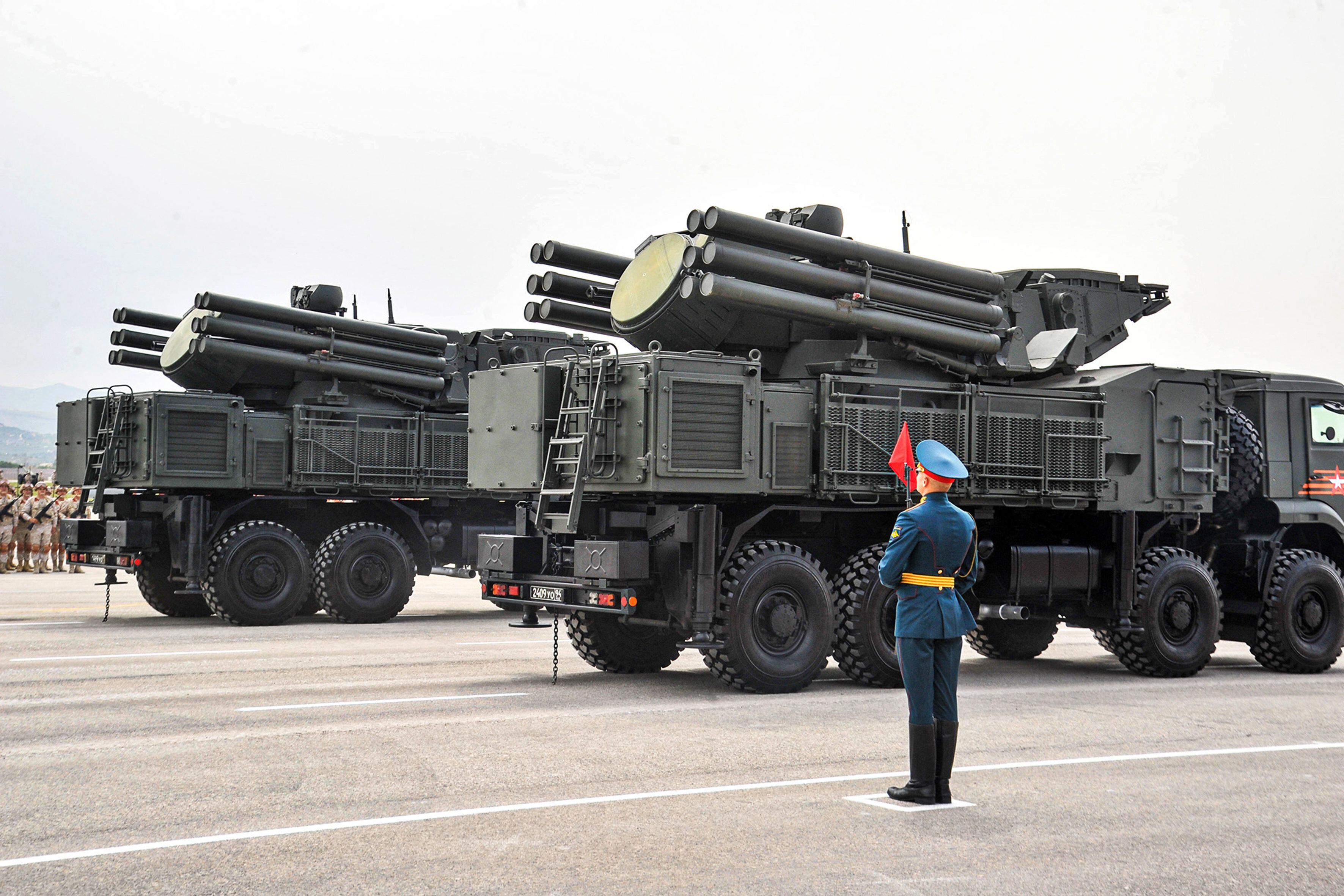 A Russian soldier stands next to SA-22 Pantsir-S surface-to-air missile systems during the Victory Day military parade.  (Photo by SANA/AFP).