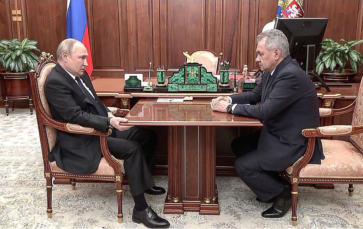 Russian President Vladimir Putin (L) speaks with Defense Minister Sergei Shoigu during their meeting at the Kremlin in Moscow.  (AFP).