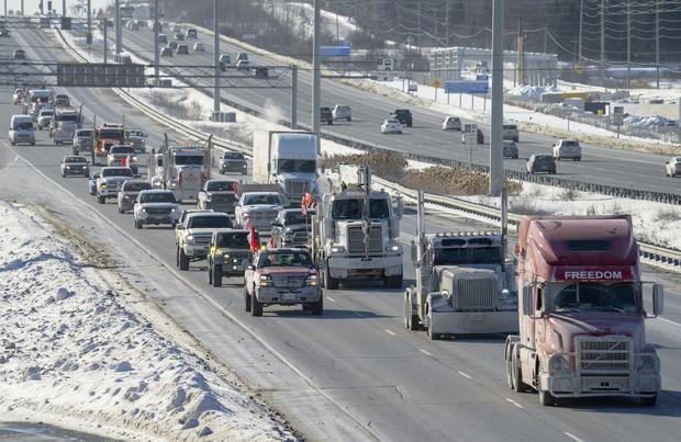 A convoy of truckers heading to Parliament Hill in Ottawa to participate in a cross-country truck convoy in protest of measures taken by authorities to slow the spread of COVID-19.  (Frank Gunn/The Canadian Press via AP)
