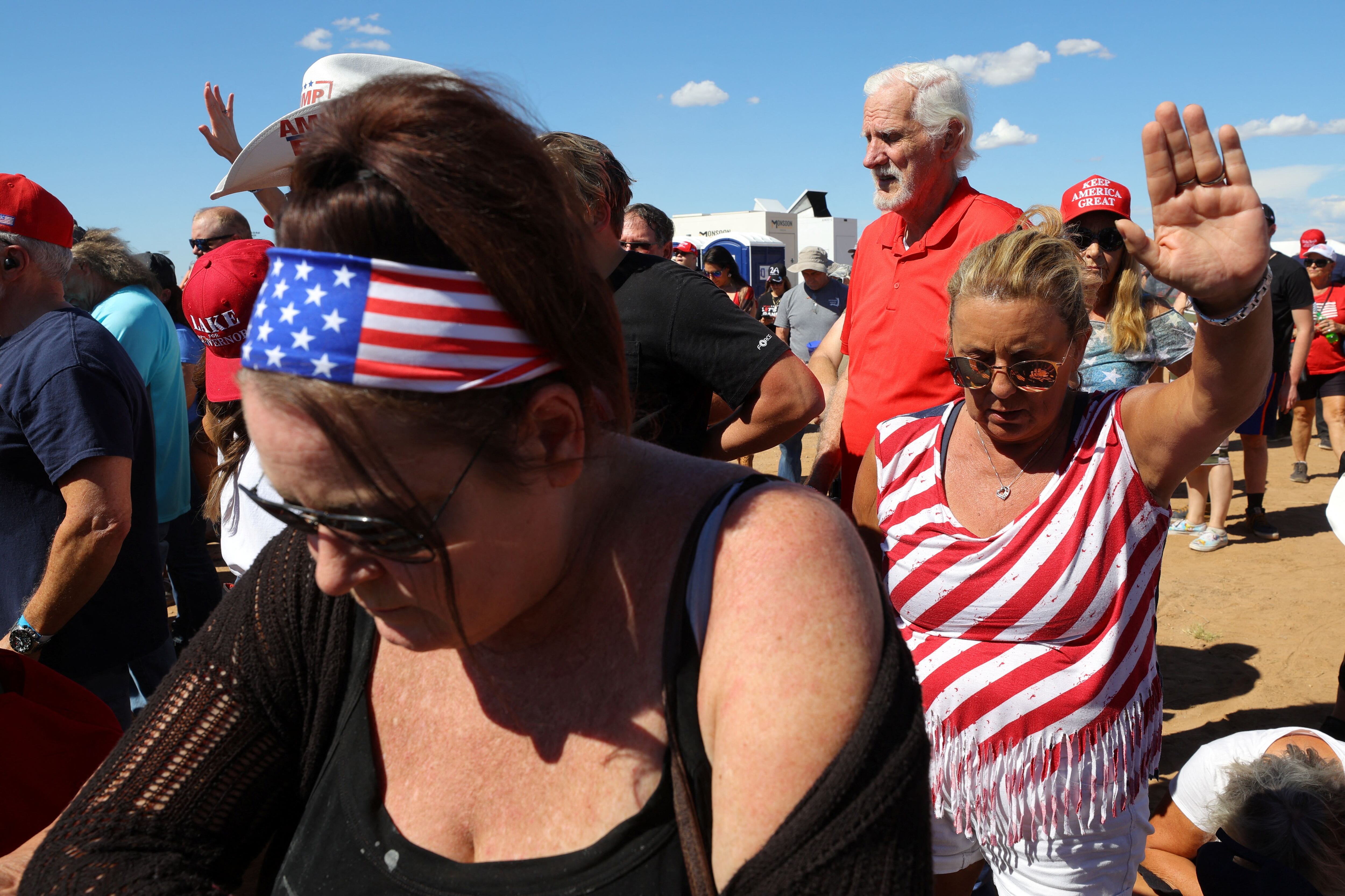 Republican supporters pray before the start of a rally in Mesa, Arizona.  REUTERS/Brian Snyder