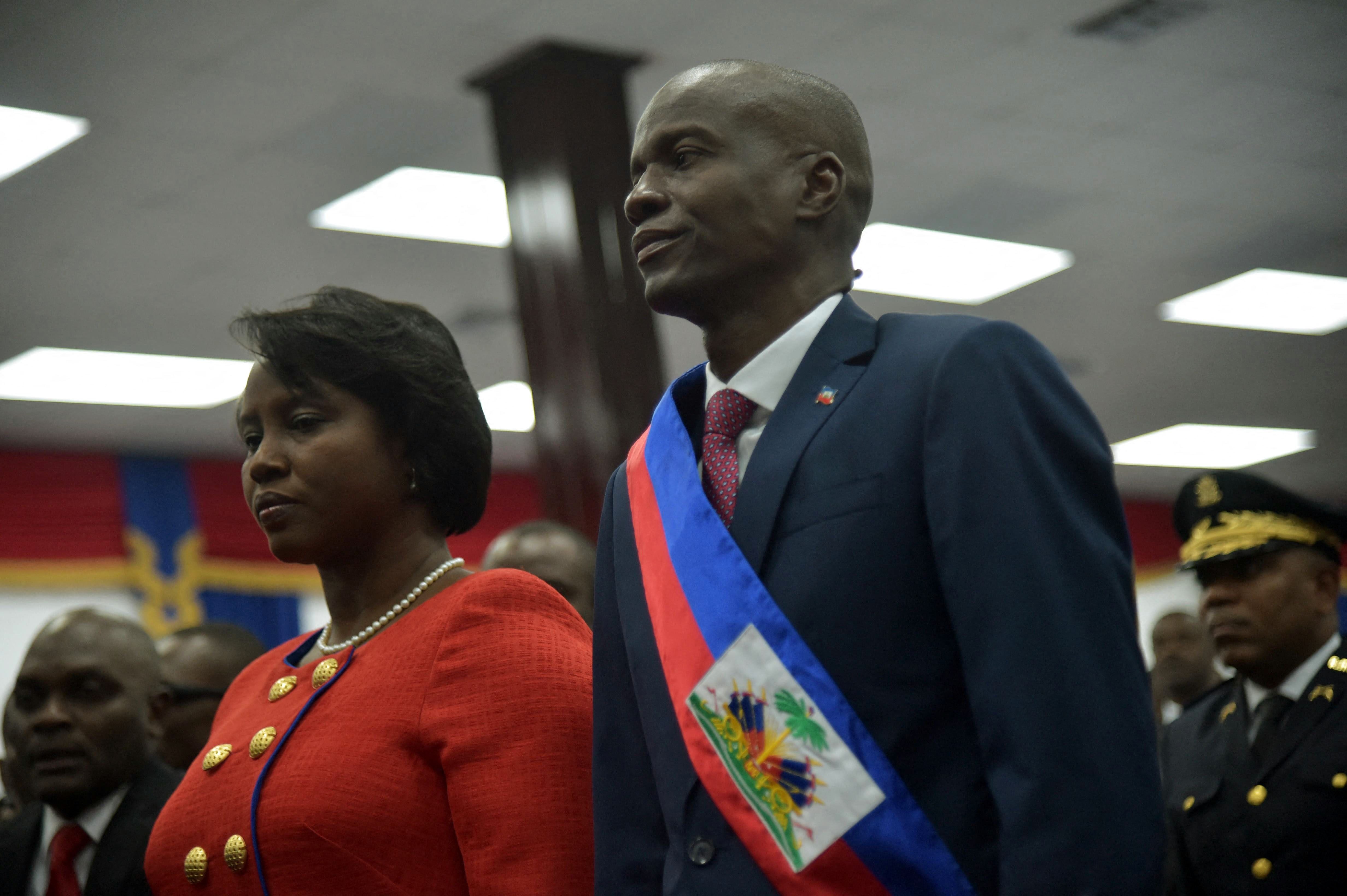 The new Haitian president, Jovenel Moise, with his wife Martine after receiving his sash during his inauguration, on February 7, 2017. (Photo by HECTOR RETAMAL / AFP).