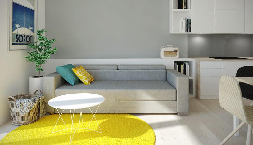 Destellos de color. La sala presenta un sofá de dos cuerpos y de respaldar bajo, dando un efecto de mayor altura en el espacio. La alfombra amarilla es el punto máximo de color, y por su forma circular, aligera visualmente el lugar.