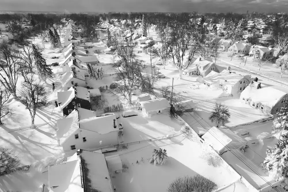 In this drone image, snow blankets a neighborhood in Cheektowaga, New York, United States, on Sunday, Dec. 25, 2022. (John Waller via AP)