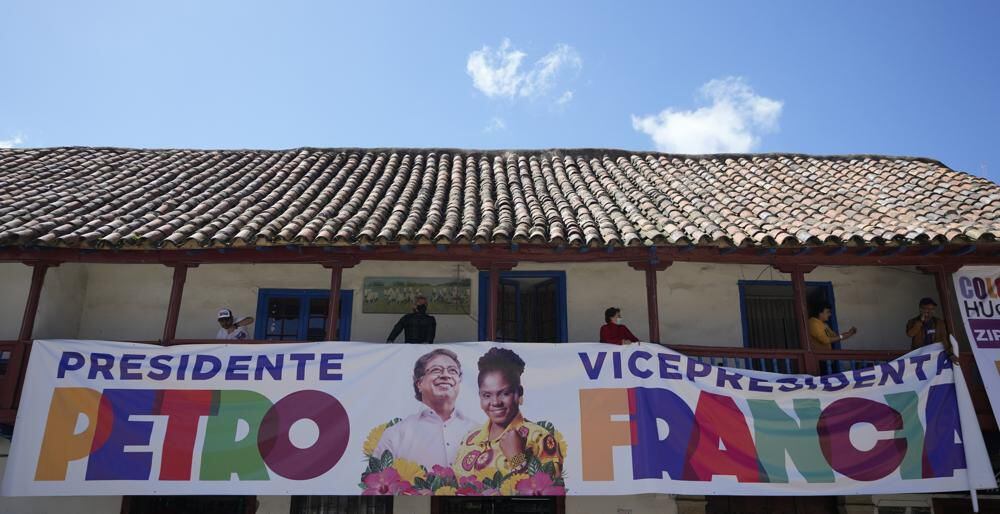 Supporters of the presidential candidate of the Historical Pact coalition, Gustavo Petro, hold an electoral banner of Petro and his running mate Francia Márquez.  (AP Photo/Fernando Vergara)