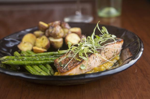 Grilled salmon with mango chutney, accompanied by golden cocktail potatoes and grilled asparagus.