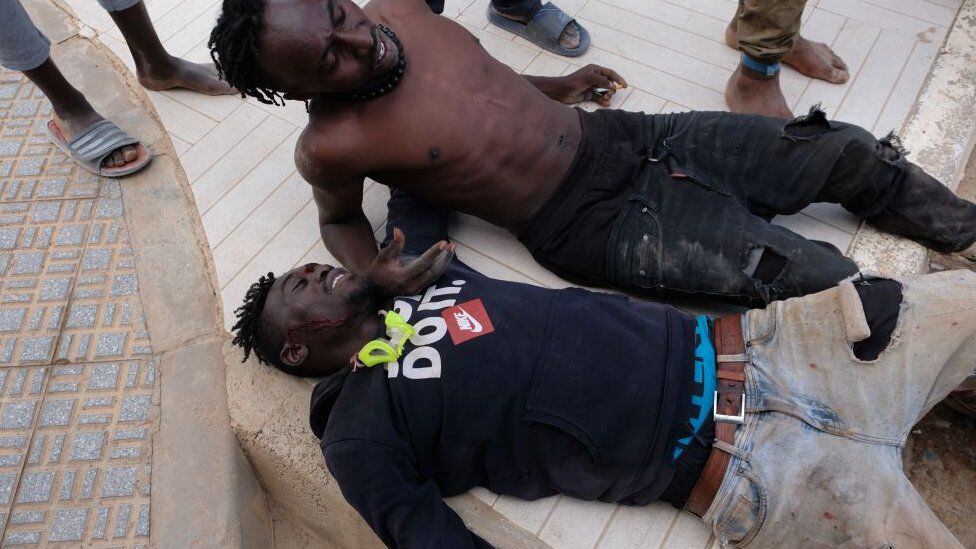 In several photos released, blood can be seen on the body of the migrants.  (GETTY IMAGES).