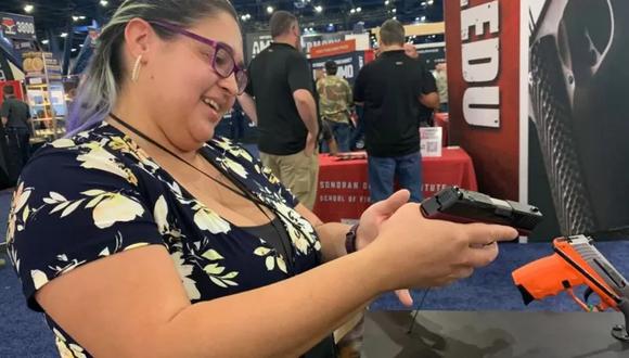 Una veterana de guerra examina un arma durante la convención de la NRA. GETTY