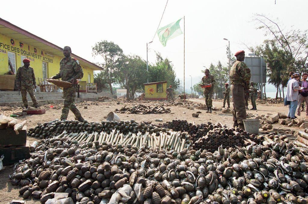 Rwandan soldiers stand in front of the remains of genocide victims.  (GETTY).
