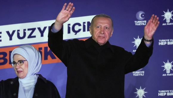 El presidente turco Tayyip Erdogan (R), acompañado por su esposa Ermine Erdogan (L), saluda a los partidarios en la sede del Partido AK en Ankara, Turquía, el 15 de mayo de 2023. Turquía se prepara para su primera segunda vuelta electoral después de una noche de gran dramatismo. (Foto por Adem ALTAN / AFP)