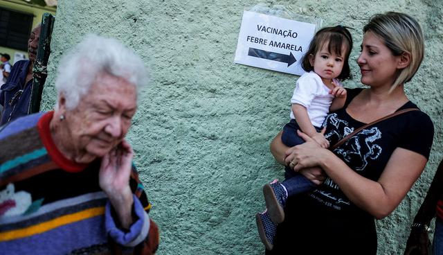 A sign reading "Yellow Fever Vaccination" is seen next to citizens that are waiting to receive the yellow fever vaccine in Sao Paulo, Brazil October 25, 2017. REUTERS/Nacho Doce