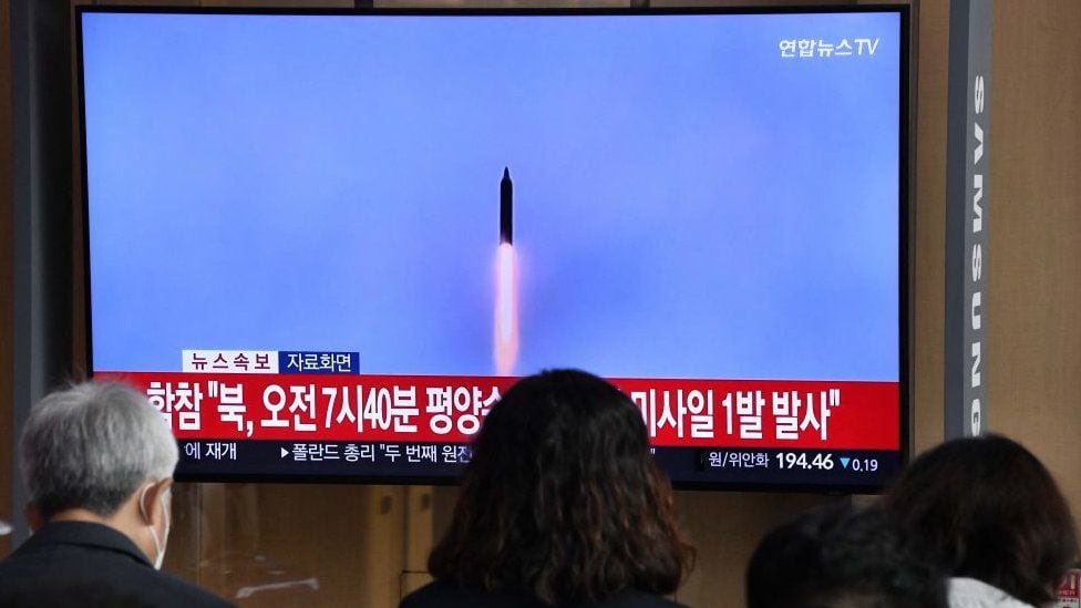People watch a TV screen showing a newscast with archival footage of a North Korean missile test, at a train station in Seoul on Nov. 3, 2022. (GETTY IMAGES)