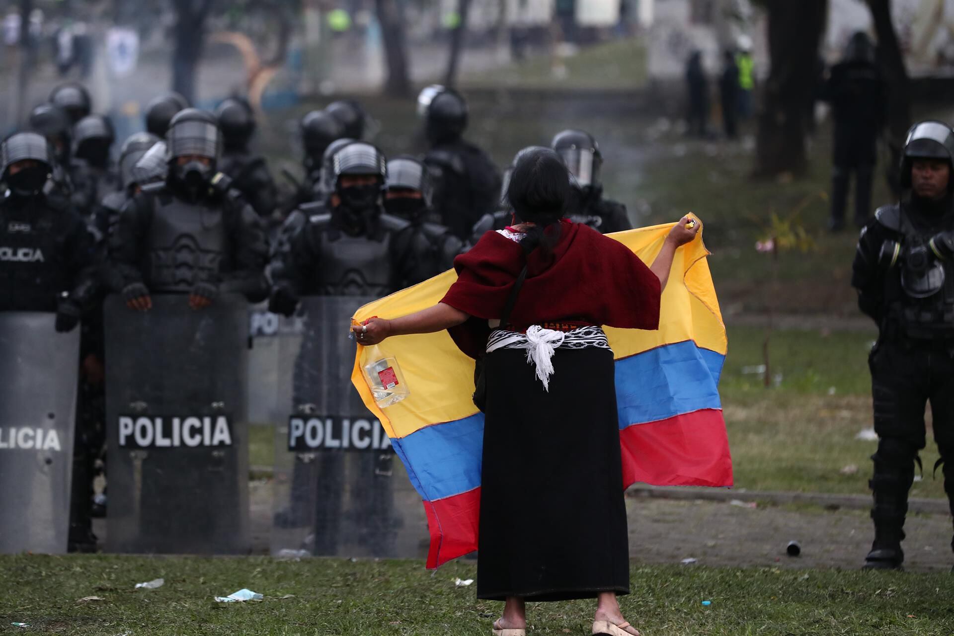 An indigenous woman waves an Ecuadorian flag as she demonstrates against the government of President Guillermo Lasso in Quito.  (EFE/ José Jácome).