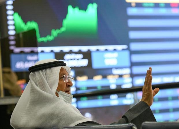 A trader inside the trading room of Boursa Kuwait, the Kuwait Stock Exchange, on March 7, 2022. The ongoing Russian invasion of Ukraine has had a harsh impact on global markets, with stocks plummeting across the globe.  (EFE/EPA/Noufal Ibrahim).