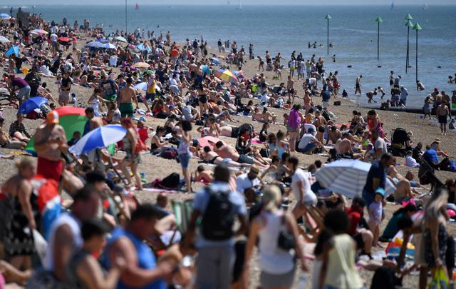 Los amantes de la playa disfrutan del sol mientras toman el sol en la playa y juegan en el mar, en el feriado bancario de mayo en Southend-on-Sea. (AFP / Ben STANSALL).