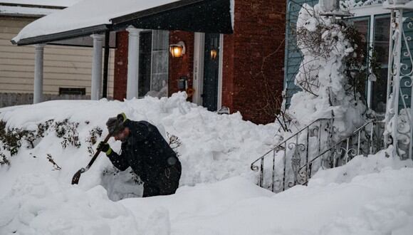 Un residente excava en la nieve en Buffalo, Nueva York, el 27 de diciembre de 2022, durante el impacto de la tormenta invernal Elliot. (Joed Viera / AFP).