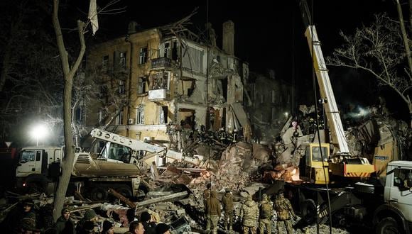Los rescatistas retiran escombros en un edificio de apartamentos destruido alcanzado por un cohete durante la noche en el centro de Kramatorsk el 1 de febrero de 2023, en medio de la invasión rusa de Ucrania. (Foto de Yasuyoshi CHIBA / AFP)