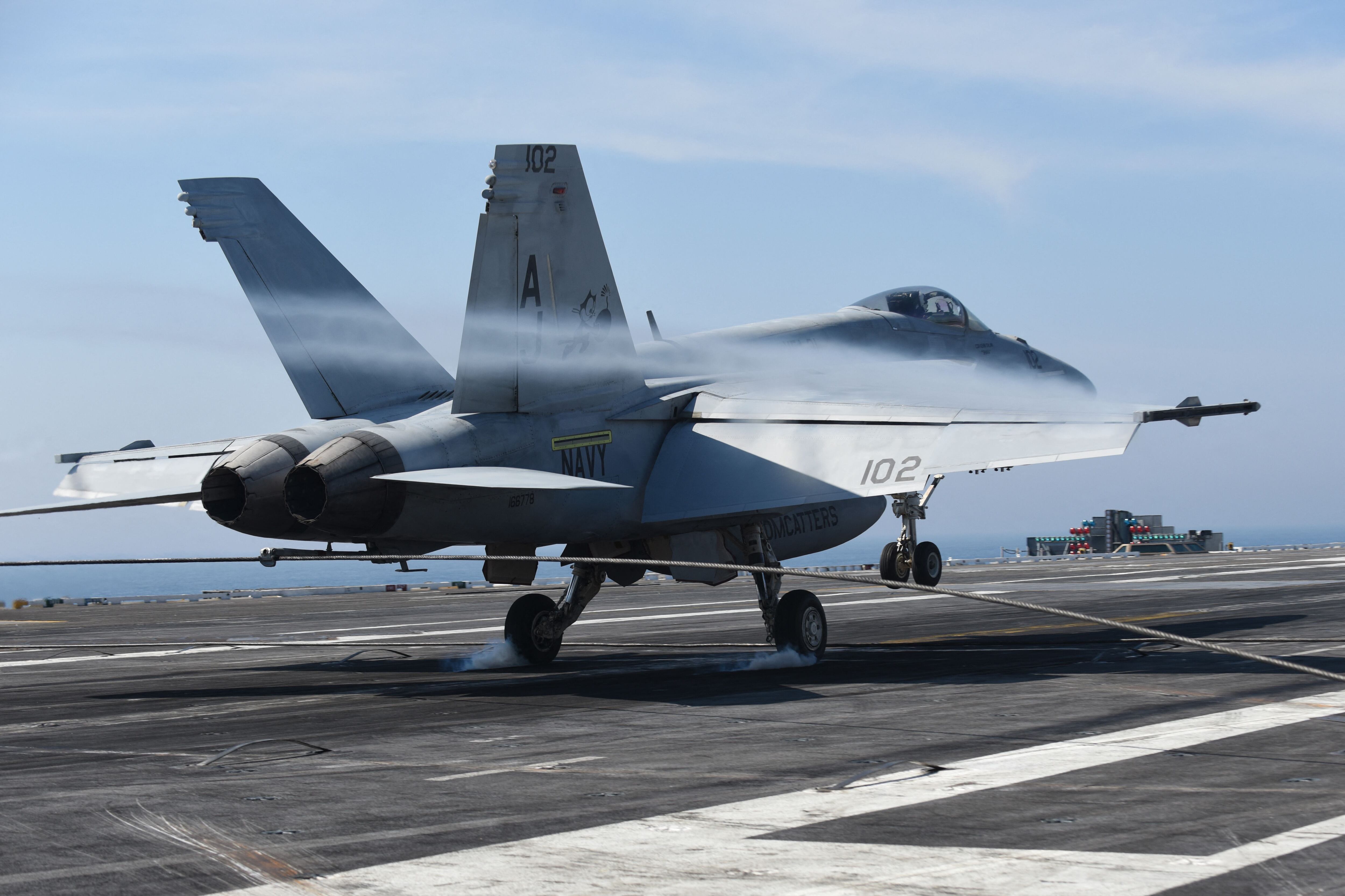 An F-18 Hornet aircraft lands on the deck of the aircraft carrier USS George HW Bush on May 11, 2018, in the Atlantic Ocean.  (Photo by Eric BARADAT/AFP).