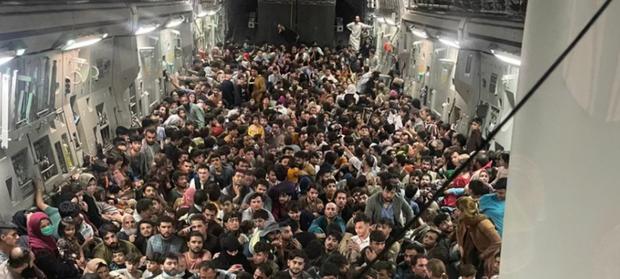 Afghans who had been authorized to evacuate began to climb onto the plane when they noticed that the plane's ramp remained half-open. (Photo: Twitter).