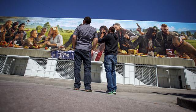 A pedestrian uses a smartphone to photograph a billboard for the Ubisoft Entertainment SA "Far Cry 5" video game displayed outside the Los Angeles Convention Center ahead of an Ubisoft event in Los Angeles, California, U.S., on Monday, June 12, 2017. For three days, leading-edge companies, groundbreaking new technologies and never-before-seen products is showcased at E3. Photographer: Troy Havey/Bloomberg