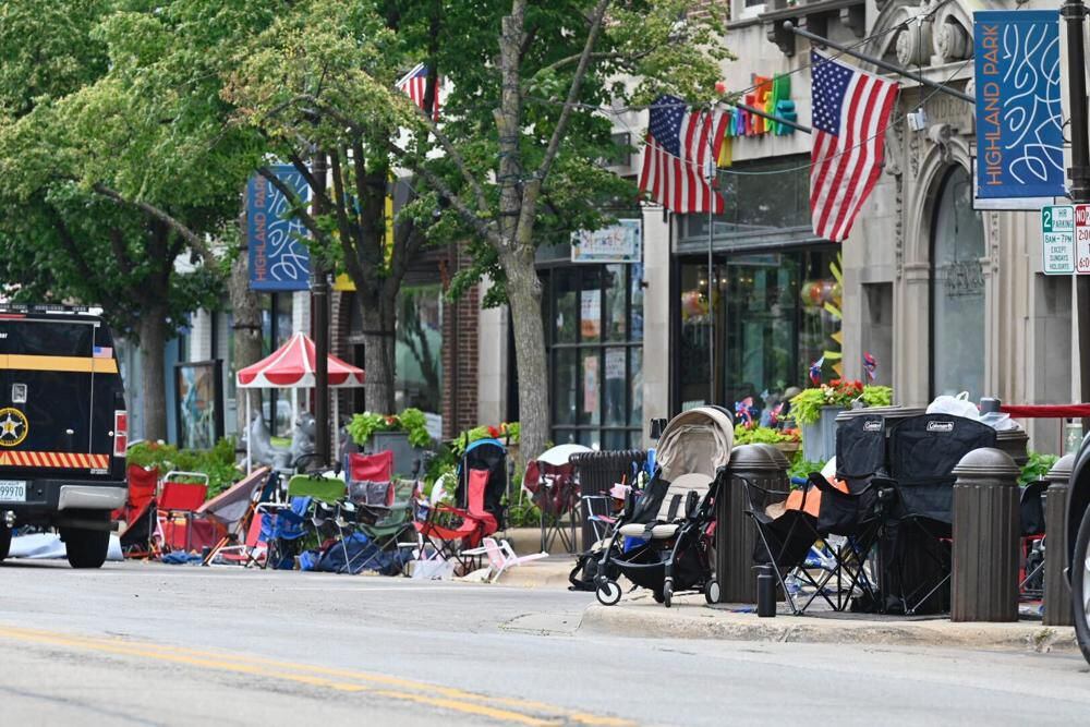 Empty chairs line the sidewalk after parade goers fled due to a shooting in Highland Park, United States, on Monday, July 4, 2022. (Tyler Pasciak LaRiviere/Chicago Sun-Times via AP)