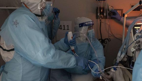 Personal médico realiza una endoscopia en un paciente que sufre de coronavirus en la unidad de cuidados intensivos (UCI) del United Memorial Medical Center de Houston el 16 de noviembre de 2020. (Nakamura / Getty Images / AFP).