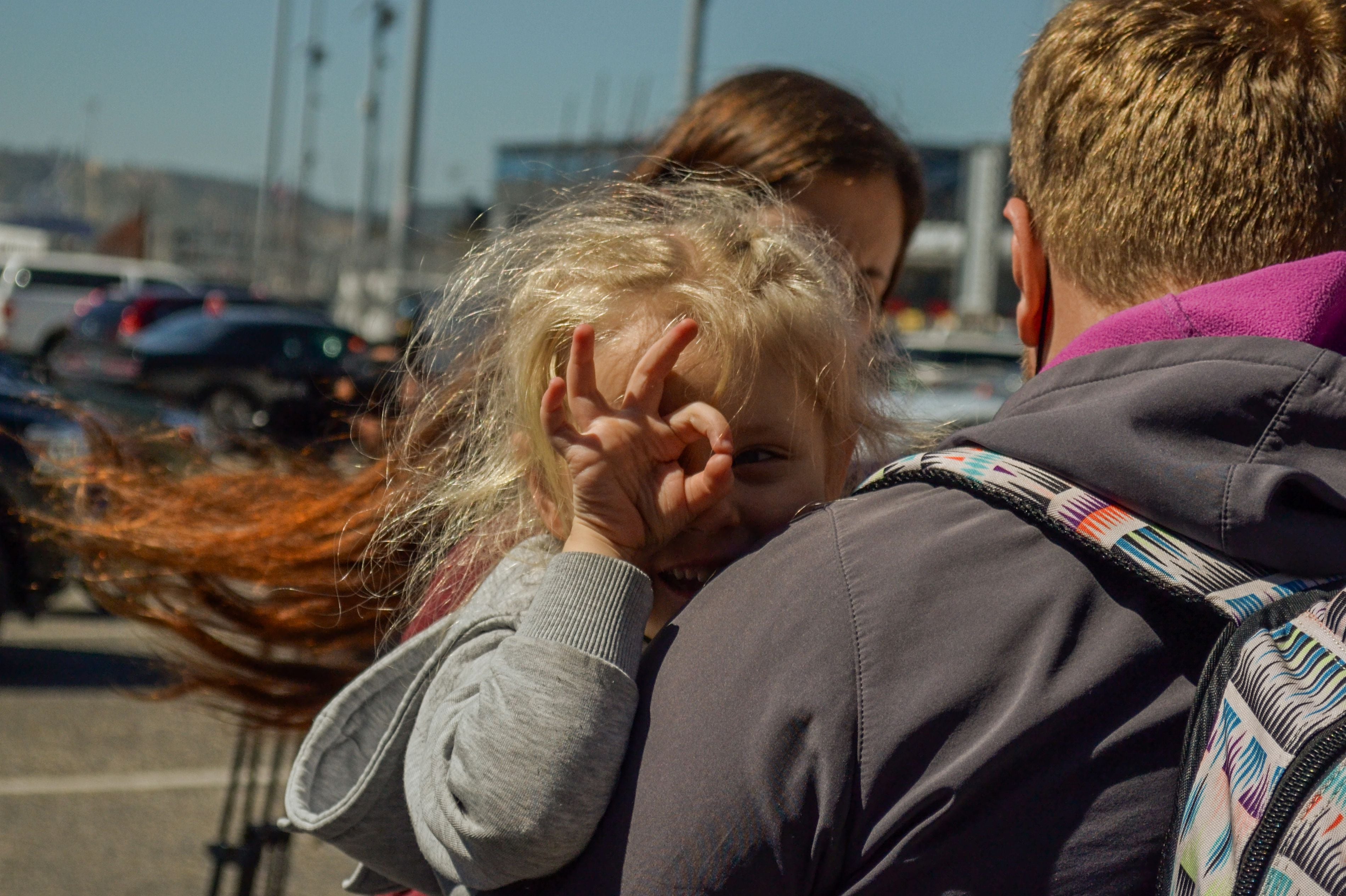 A girl, part of the group of families from Russia and Ukraine waiting to apply for Political Asylum, reacts while waiting at the San Ysidro port of entry, to try to enter the United States, in the city of Tijuana, state of Baja California (Mexico).  (EFE/Joebeth Terriquez).