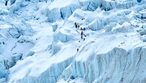 En esta fotografía tomada el 2 de mayo de 2021, los montañistas caminan a lo largo del glaciar Khumbu, cerca del campamento base del Everest.
(PRAKASH MATHEMA / AFP).