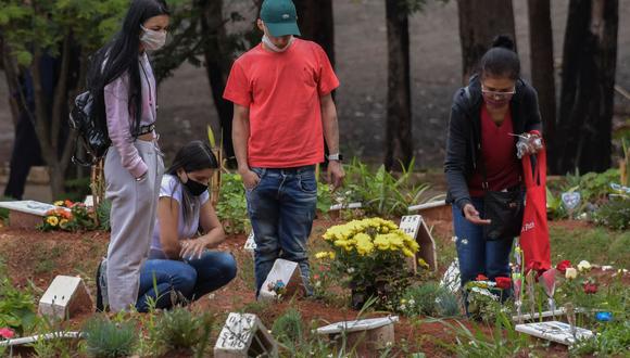 La gente rinde homenaje a sus seres queridos para conmemorar el Día de Muertos en el cementerio de Vila Formosa, el más grande de América Latina, en Sao Paulo, Brasil, el 2 de noviembre de 2020. (NELSON ALMEIDA / AFP).