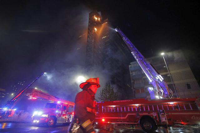 El edificio corporativo de Enel ubicado cerca de la avenida Alameda, en Santiago de Chile, era consumido por el fuego este viernes. (Foto: AFP)