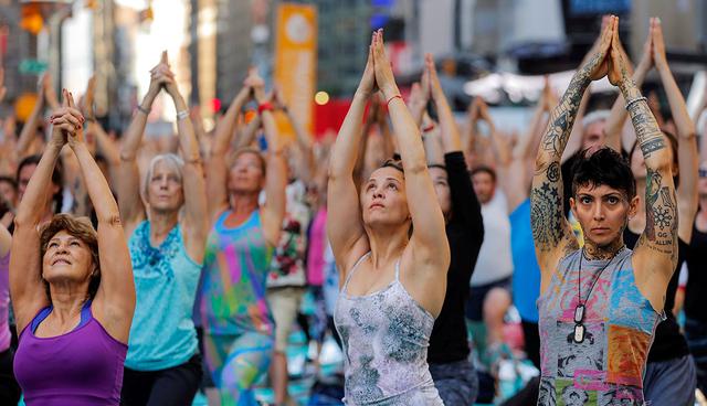 People participate in a yoga class during an annual Solstice event in the Times Square district of New York, U.S., June 21, 2017. REUTERS/Lucas Jackson