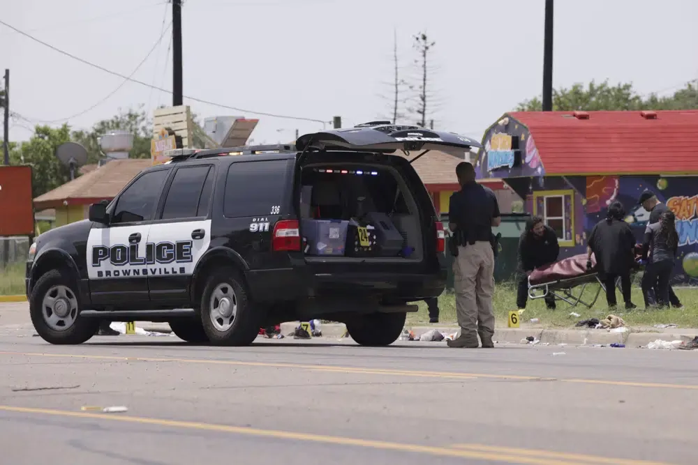 Police carry the bodies of the victims of the hit-and-run in Brownsville, Texas.  (AP Photo/Michael Gonzalez)