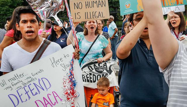 Laurel Hoa, of Kensington, Md., center, holds up a sign that says "no human is illegal," with her son Gabe Hoa, 3, during a rally in support of the Deferred Action for Childhood Arrivals program known as DACA, outside of the White House, in Washington, Tuesday, Sept. 5, 2017. President Donald Trump's administration will "wind down" a program protecting hundreds of thousands of young immigrants who were brought into the country illegally as children, Attorney General Jeff Sessions declared Tuesday, calling the Obama administration's program "an unconstitutional exercise of authority."
 (AP Photo/Jacquelyn Martin)