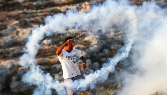 Las fuerzas de Israel disparan bombas lacrimógenas contra un palestino que protesta contra la destrucción de la aldea beduina de Jan al Ahmar. (AFP).