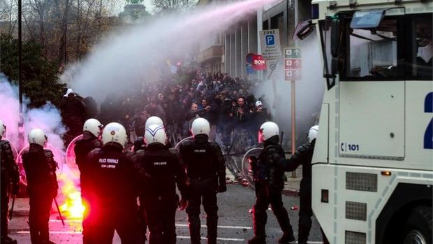 Riot police in Belgium used water cannons against protesters.  (EPA).