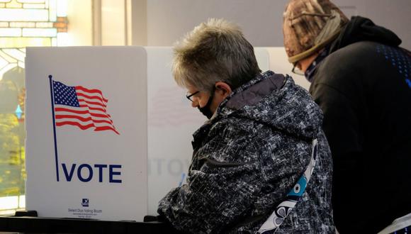 Las personas llenan las boletas en una cabina de votación durante las elecciones presidenciales de los Estados Unidos en New Richmond, Ohio, el 3 de noviembre de 2020. (REUTERS/Jeffrey Dean).