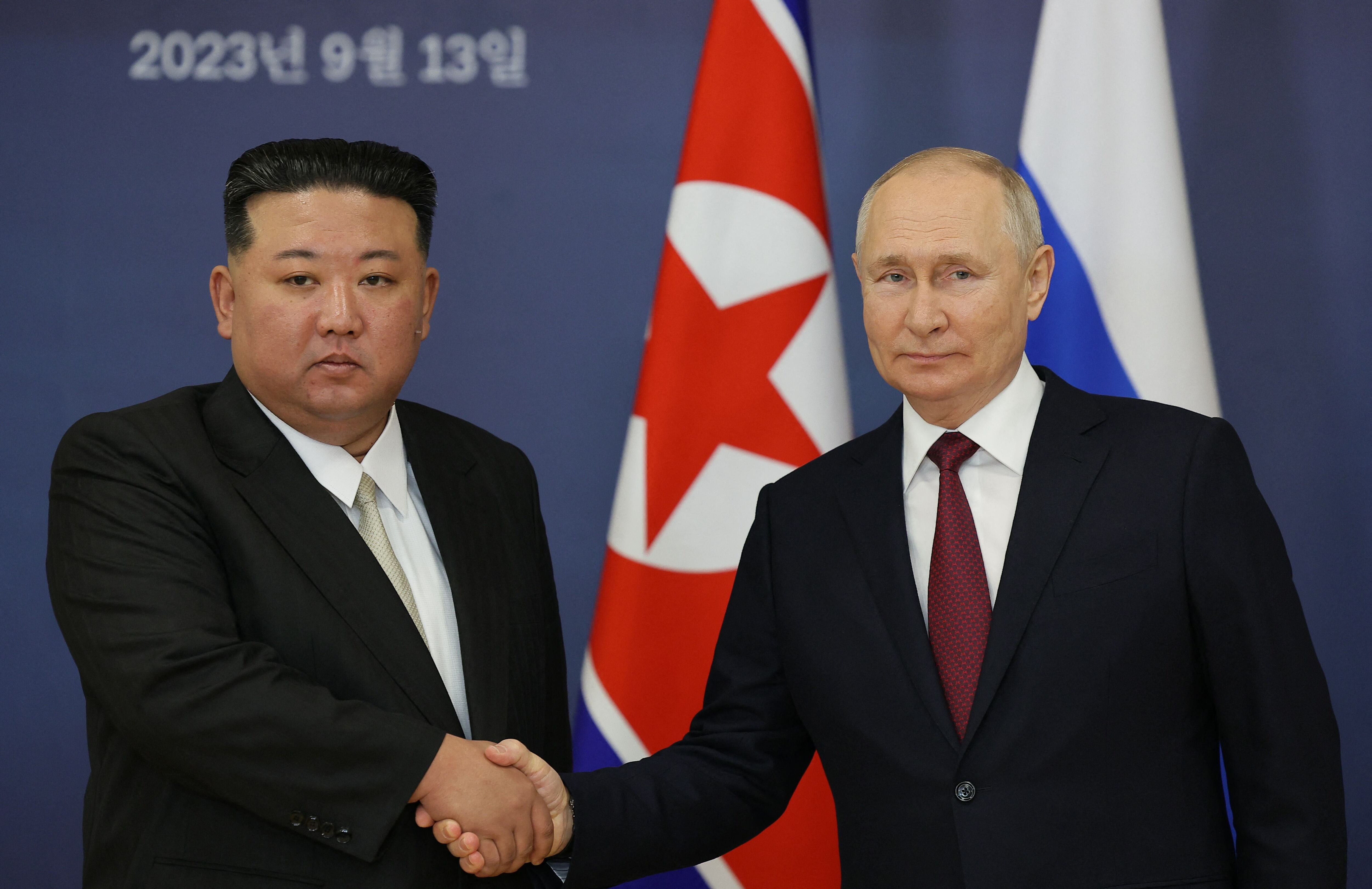 Russian President Vladimir Putin and North Korean leader Kim Jong-un shake hands during a meeting at the Vostochny cosmodrome, in the Amur region, on September 13, 2023. (Photo by Vladimir SMIRNOV / AFP).